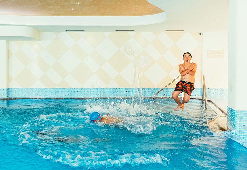 Piscina esterna dell'hotel con vista Dolomiti